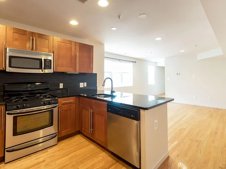 Kitchen with gas stove and dishwasher. Look at that light flooding in!
