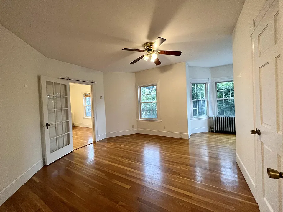 Bedroom with bay window and walk-through closet