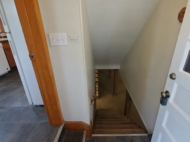 Entry from Side door. Kitchen to the left, basement stairs straight ahead.