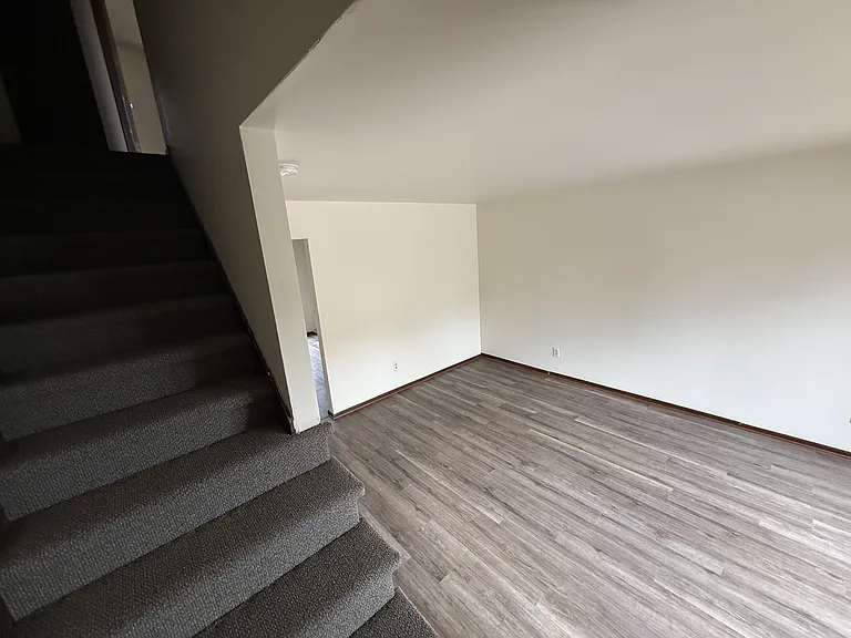 Living room and stairs to upstairs. All new floor covering. Easy maintenance.