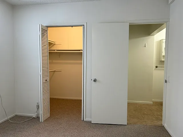 Walk in closet and private bathroom in primary bedroom.