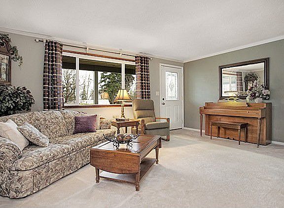 Living room looks out to front yard and has great light from newer vinyl window. Crown molding and d