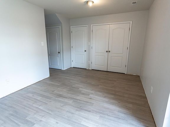 Extra living/bedroom space on ground floor. Left-most door is storage, second door is utility, double doors are laundry