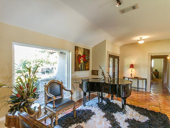Standing in the dining looking down the hallway into the second bedroom.