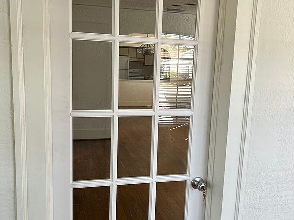 second entrance to living room separating small front bedroom