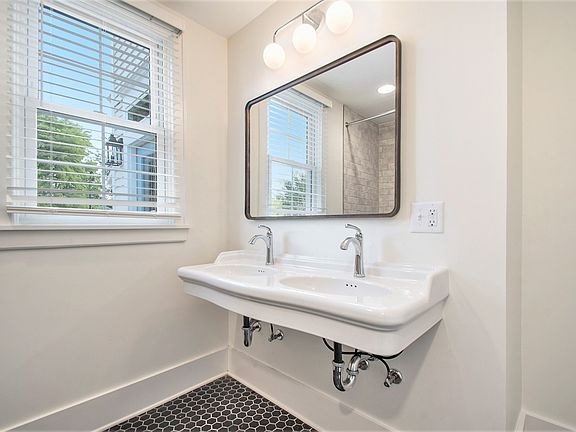 High end bathroom with double vanity and curbless shower.