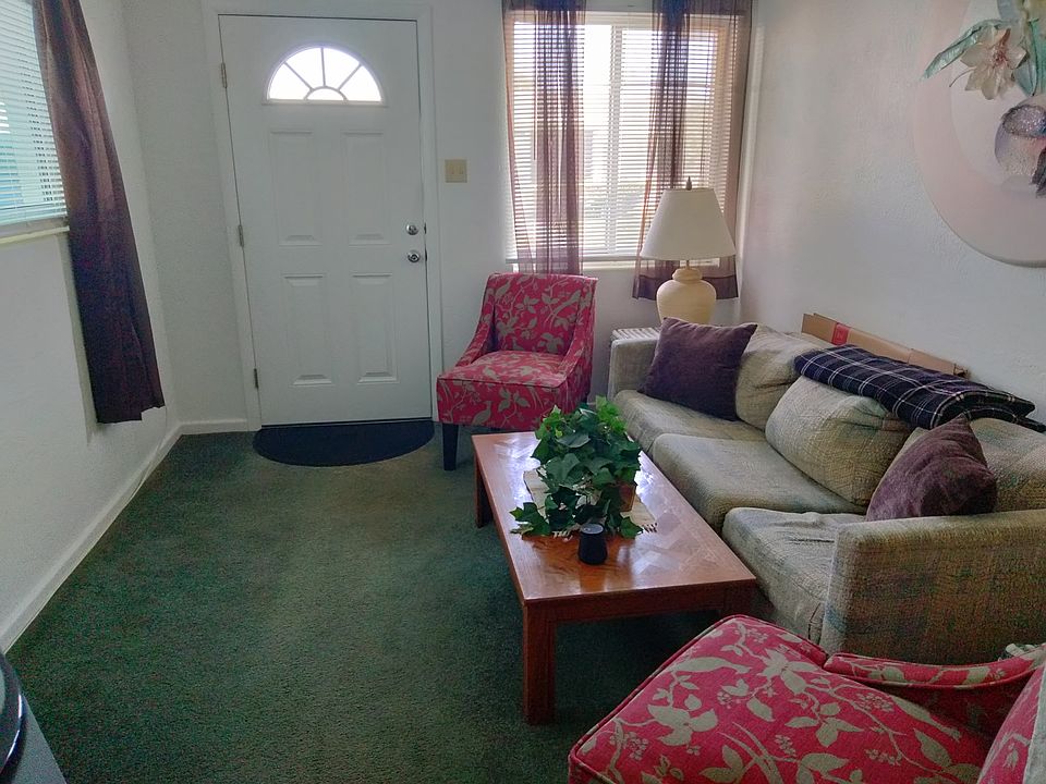 View of the front entrance door with private parking right outside the door.