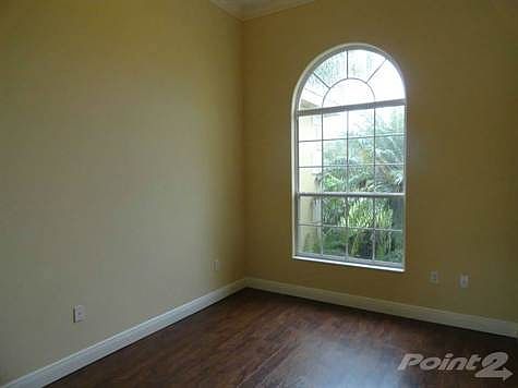 Den with wood floors and French door