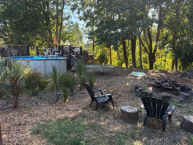 Back yard beyond fence butts up to Ash Creek.