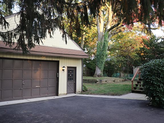 Driveway, garage, and back yard