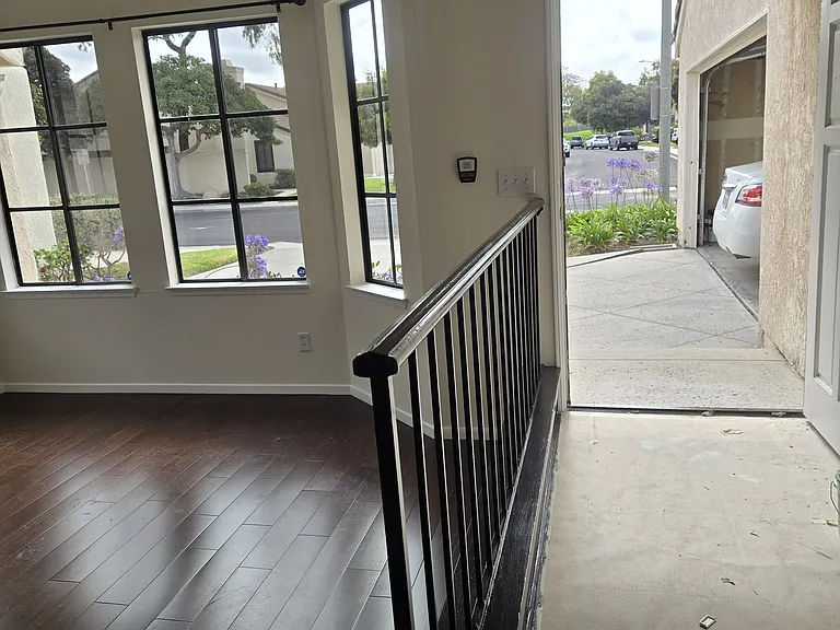 View of front door and garage from dining area.