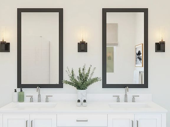 Primary bath with black-framed mirrors