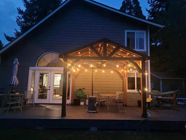 View of Deck from backyard at dusk (cozy lights on the pagoda!)