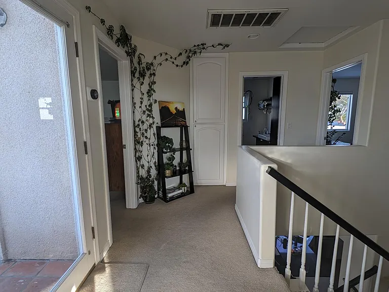 A view of the hallway upstairs with your balcony and bedroom the left, your private bathroom in the middle, and the guest bedroom/office to the right.