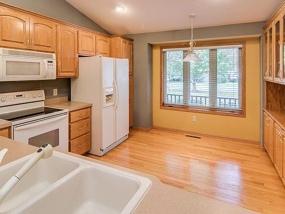 Kitchen has raised panel oak cabinets and oak hardwood floors.