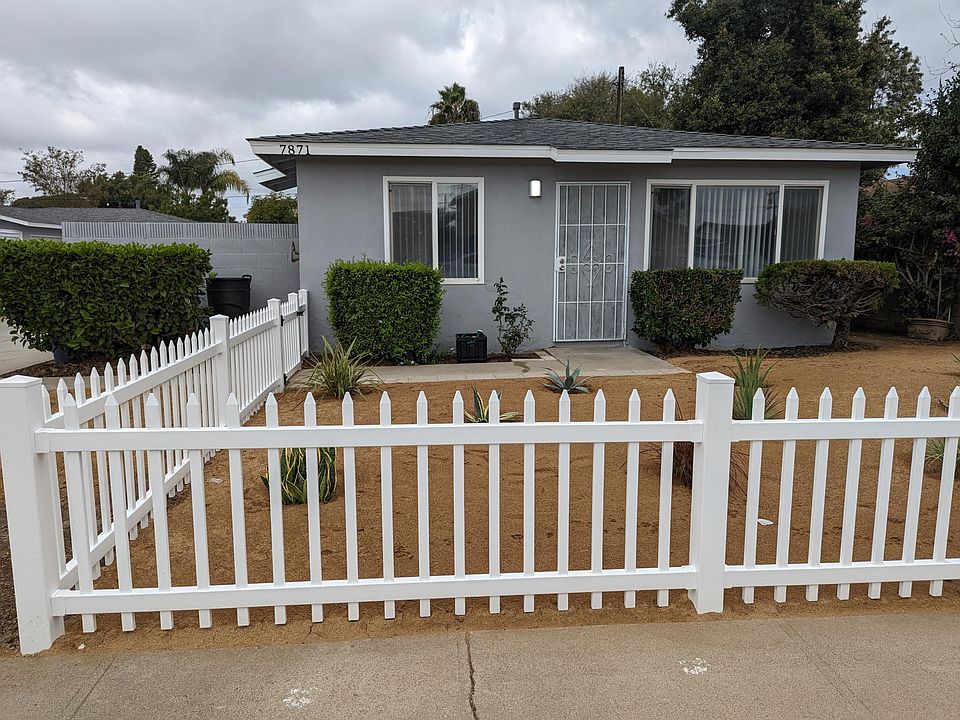 Vinyl gated front yard with garden composed of DG and drought tolerant plants.