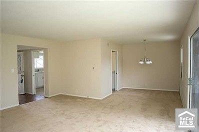 Living, dining area, entry hall, peek into kitchen