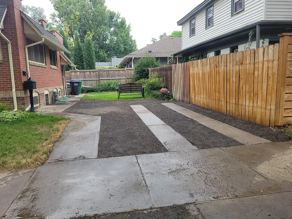 Your parking spot - 1 car on concrete strips. Glider bench just for you to enjoy flowers and greenery.