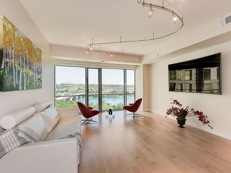 Spacious, sun-filled, furnished Living room with Curved TV, hand-painted painting and stunning views.