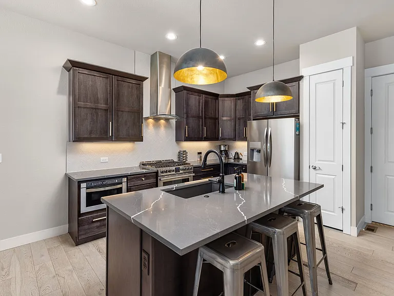 Chef's kitchen with microwave, gas oven (furniture pictured is for staging purposes only - unfurnished unit)