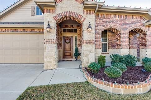 Crown moldings, oil-rubbed bronze style lighting, rounded corners, art niches, brick patterned ceramic tile and neutral paints greet guests