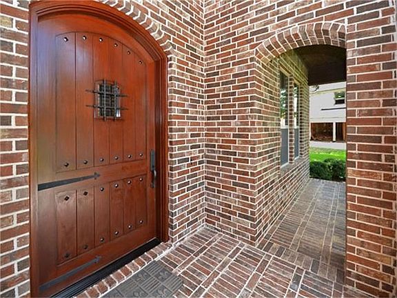 Covered front porch, extra large 40X80 front door recently re-finished.