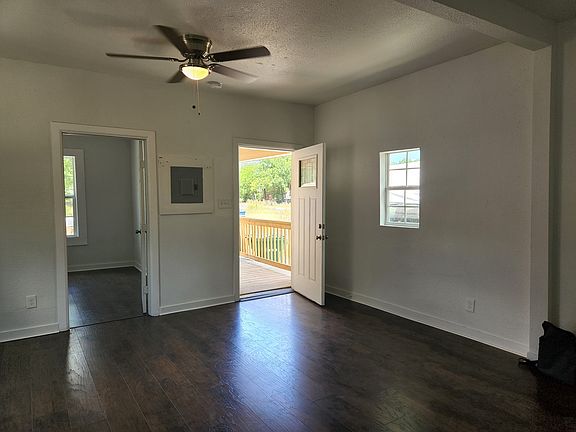 Great room looking back to front door. Door to second bedroom open at left.
