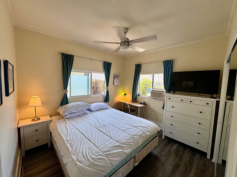 light filled, Furnished bedroom with A/C, ceiling fan, 43" LG flat TV, desk, long closet, shoe tree, dresser, wireless router w/Ethernet port, blackout curtains.
