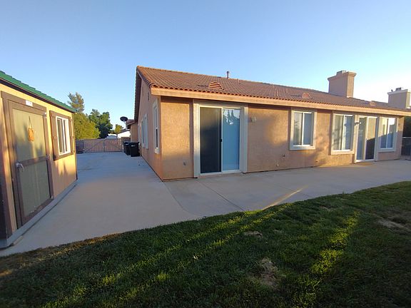 Concrete gated RV parking with 220 volt for EV charging & lighted storage shed with A/C outlets