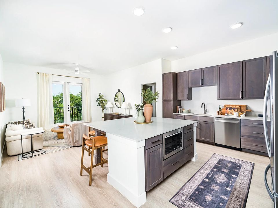 Sleek kitchens at Modera Trailhead feature spacious islands, designer finishes, and open layouts that flow seamlessly into bright living areas.