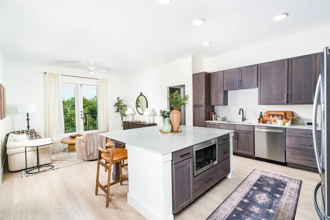 Sleek kitchens at Modera Trailhead feature spacious islands, designer finishes, and open layouts that flow seamlessly into bright living areas.