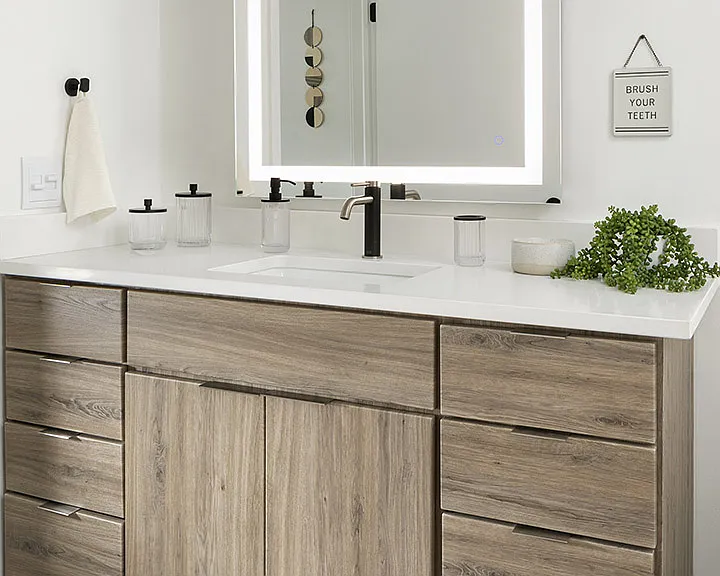 Apartment Bathroom with LED vanity mirror and hardwood flooring.