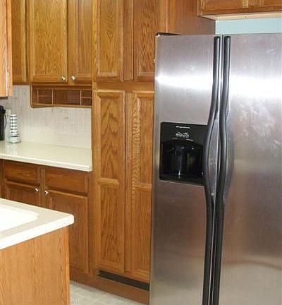 New kitchen cabinets w/ corian counters & tiled bksplash