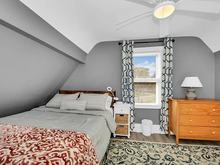 Second Bedroom features blackout curtains as well as a dresser and closet.