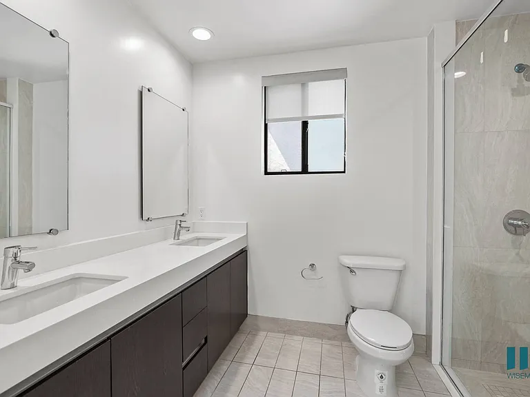 Bathroom with Double-Sink Vanity and Walk-In Shower with Glass Door