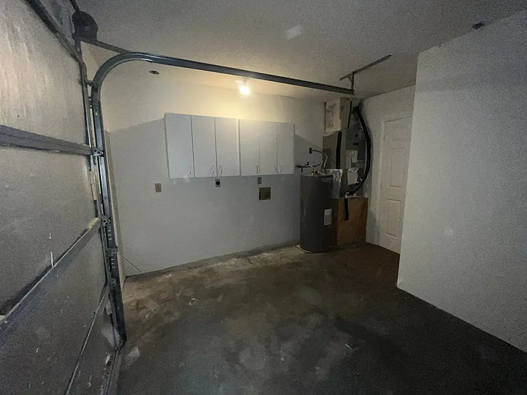 Laundry area with washer-dryer hookups and cabinets.