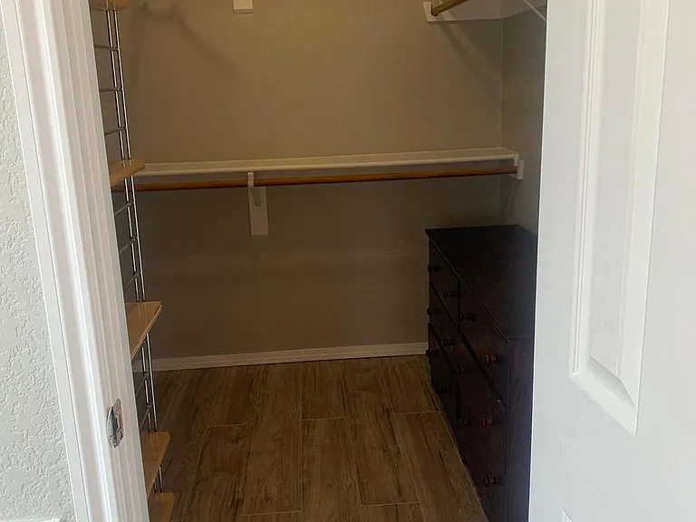 HUGE walk in Master Bedroom closet for hanging clothes and a dresser for clothing storage.