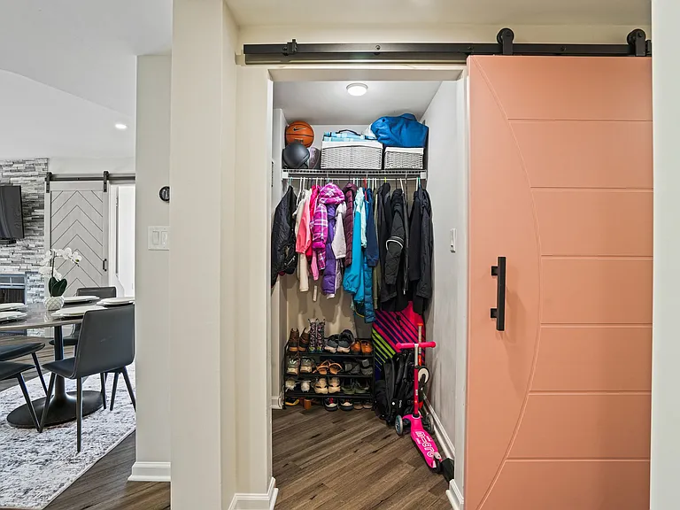 Expansive entryway closet featuring custom organization and generous storage space for all your gear