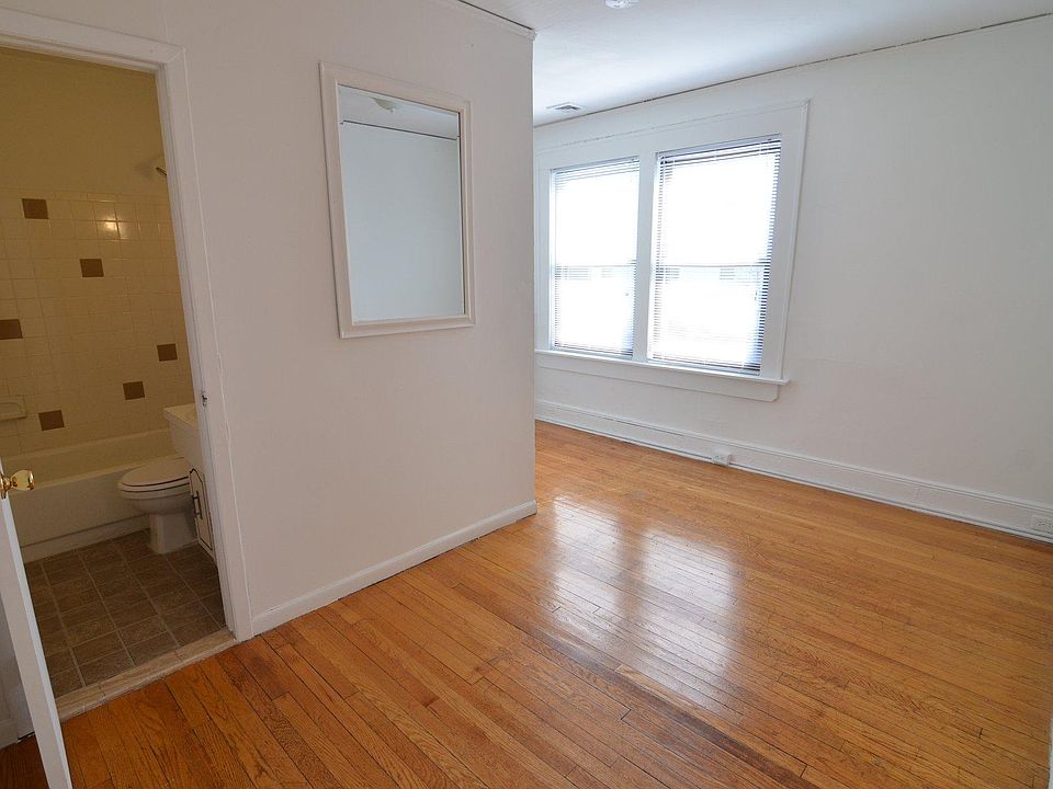 This is the main living space of the apartment. Straight ahead is the bathroom. Forward and around the corner to the left is the Kitchen. To your right (not pictured) is the door to the bedroom. The windows face east, and look out on to Deer Park Aven
