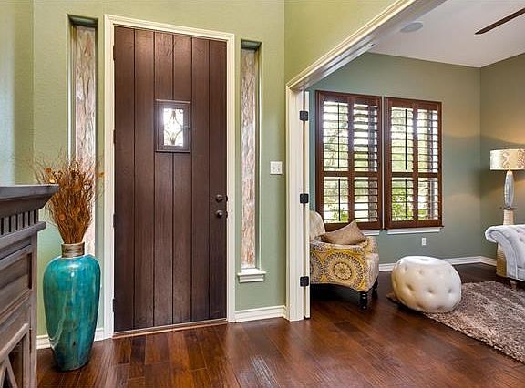 Two story entry foyer with hand scraped wood floors.