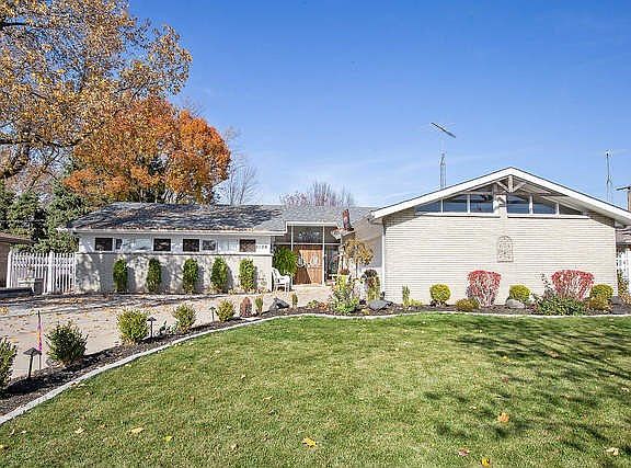 Beautiful sweeping landscape beds highlight the driveway and front yard.