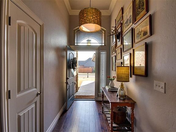 Such a cool entry with thick crown molding, wood floors and an awesome light fixture.
