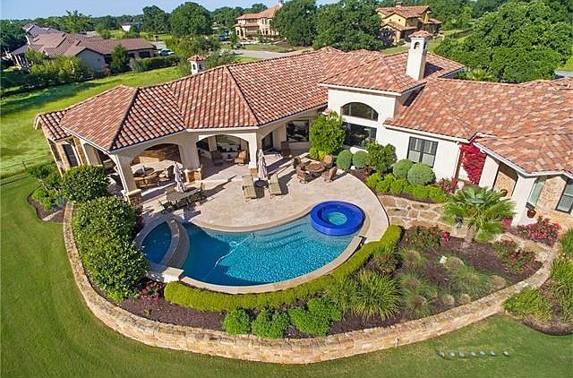 Pirvate outdoor living area of 704 Cimarron Hills Trail.  Pool and Hot Tub overlooking abundant green space and approximatey 135 yards off the 10th hole of the private Jack Nicklaus Signature golf course at Cimarron Hills Golf and Country Club