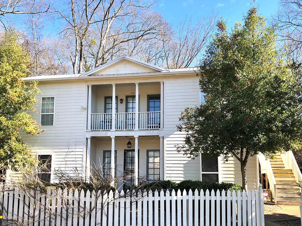 The apartment is the upstairs unit. Enter on stairs on the right side of the photo.
