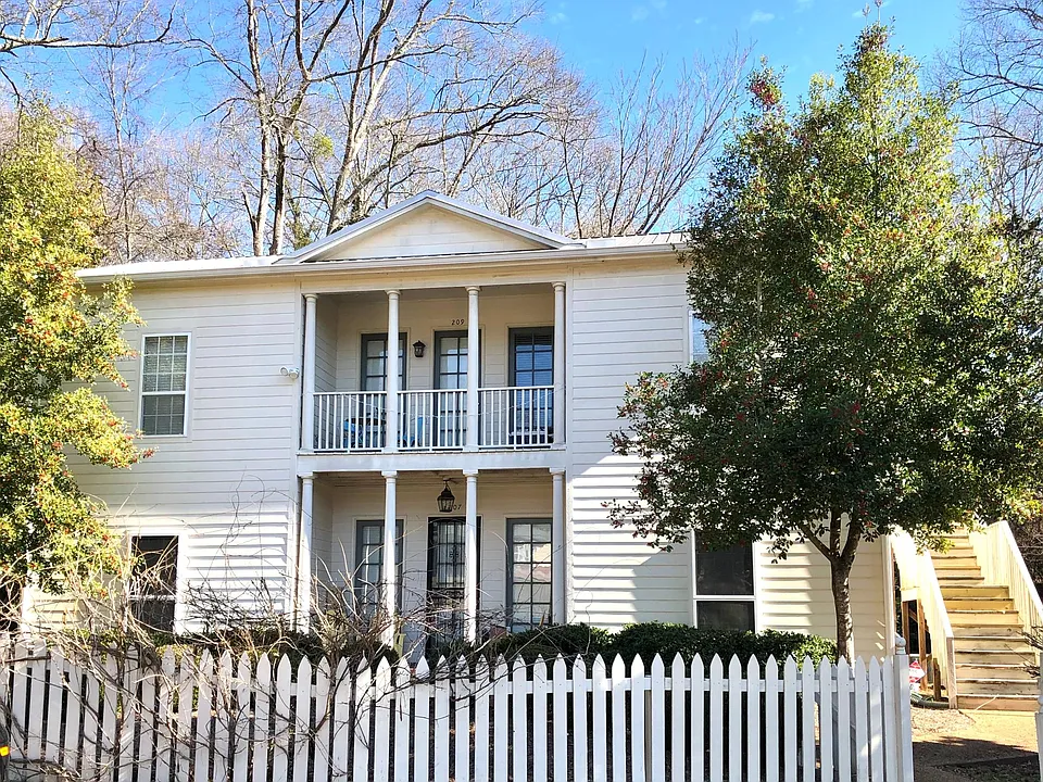 The apartment is the upstairs unit. Enter on stairs on the right side of the photo.