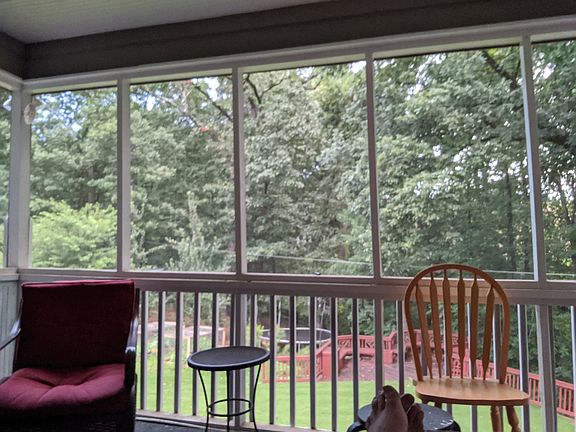 Screened in porch with panoramic view of spacious back yard, approximately 1/2 acre with wooded backdrop. Fully fenced in, very private