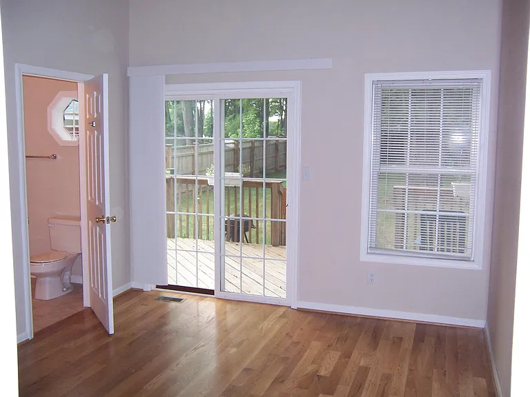 Master bedroom with hardwood floors and walk in closet.