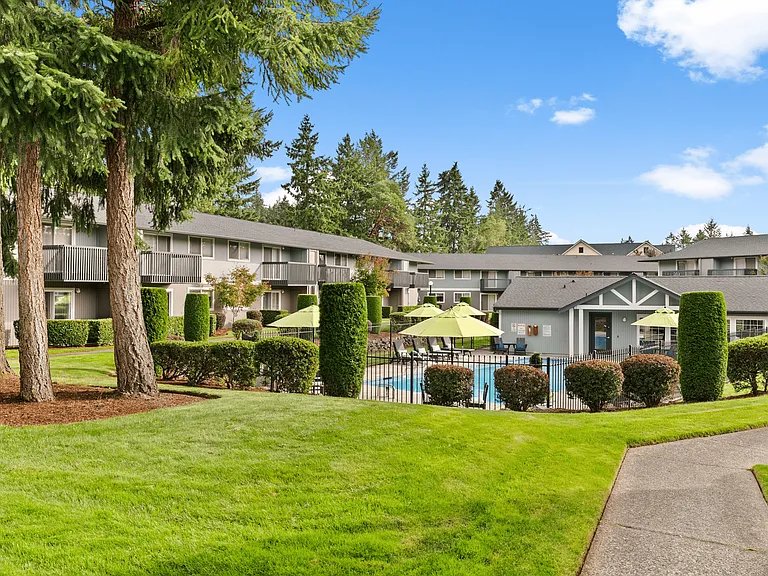 Lush green landscaping surrounds our sparkling community pool.