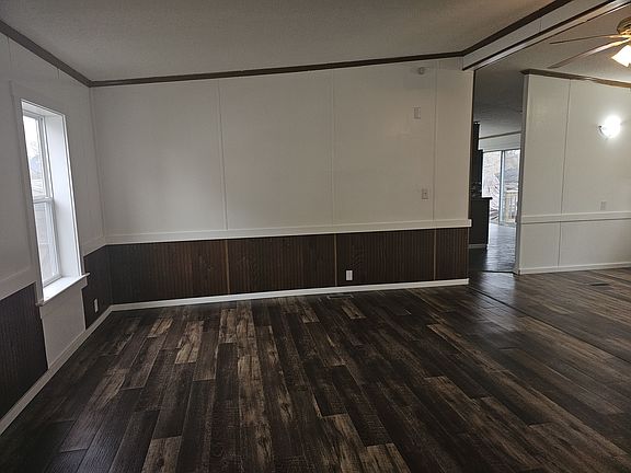 Large livingroom/family room with ceiling fan. Brand new vinyl plank flooring throughout, brand new vinyl windows, brand new trim, freshly painted.