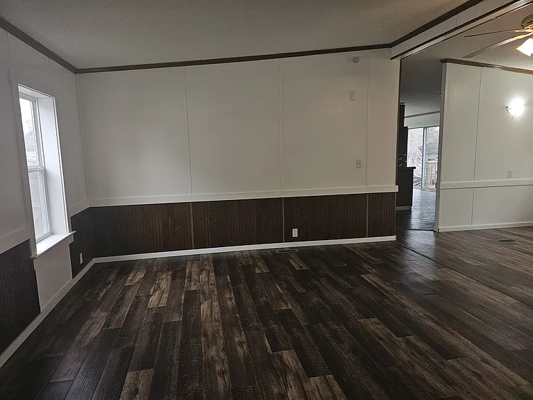 Large livingroom/family room with ceiling fan. Brand new vinyl plank flooring throughout, brand new vinyl windows, brand new trim, freshly painted.
